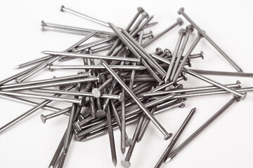 Pile of construction iron nails on a white isolated background
