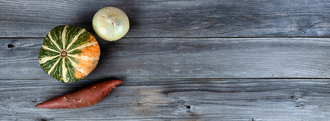 Fresh raw organic vegetables on weathered wooden boards