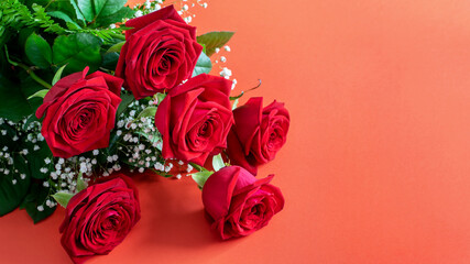Nice red roses bouquet on the deep pink background closeup, banner. Greeting card design for Womens day, Mother's day or Valentine's day.