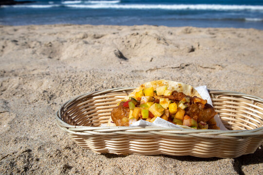 A Fish Taco Topped With Tropical Mango Salsa Served In A Basket On The Beach In Mexico