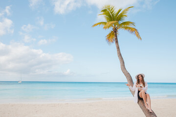 Beautiful woman sitting on palm on sea background