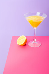 Refreshing yellow lemon cocktail in glass on table