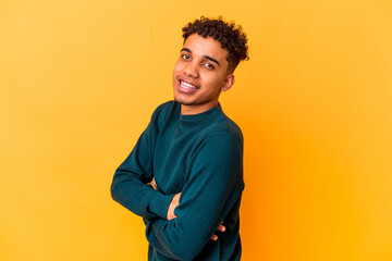 Young african american curly man isolated on purple happy, smiling and cheerful.