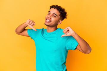 Young african american curly man isolated on purple feels proud and self confident, example to follow.