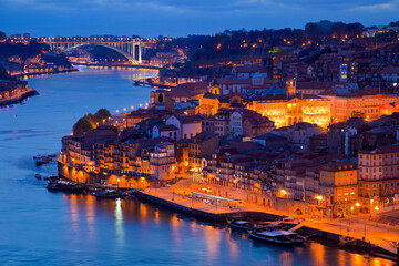 Fototapeta na wymiar Portugal, Porto. View of city and harbor at night.