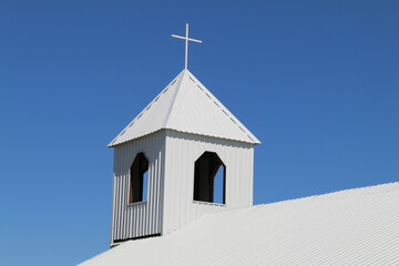 rural small town white church steeple chimes bell tower rooftop with blue sky