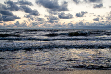 Evening seascape with clouds and waves.