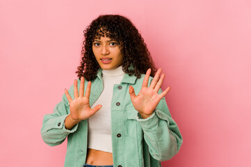 Young african american afro woman isolated rejecting someone showing a gesture of disgust.