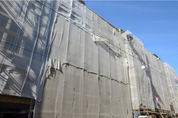 Zagreb, Croatia after a series of earthquakes. Damaged buildings in city center. Catastrophic earthquake caused widespread damage. Reconstruction of the building protected by large canvas.