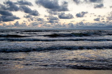Evening seascape with clouds and waves.