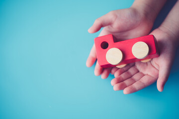 Delivery truck on hands.Insurance car.Transport.Finance business.Truck delivery.Rent sell Second hand car.Wooden truck toy in kid hands.Motor service, support, Repair, safety, Warranty service.