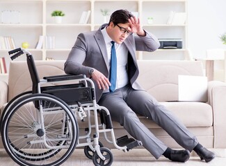 Dsabled businessman on wheelchair working home