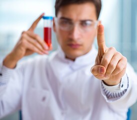 Man doctor checking blood samples in lab