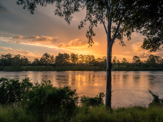 Beautiful Riverside Sunset with Dramatic Sky and Reflections