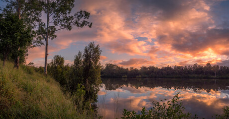 Panoramic Riverside Sunrise with Dramatic Cloud Reflections