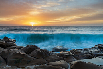 High Cloud Sunrise Seascape from Rock Platform