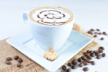 Cup of colombian coffee, decorated on white wooden background