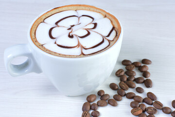 Cup of colombian coffee, decorated on white wooden background