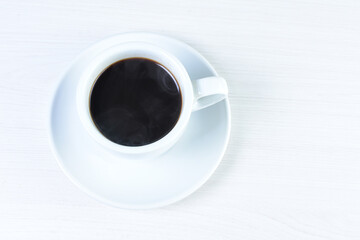 Cup of colombian coffee, decorated on white wooden background