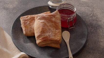 Puff pastry turnovers with jam rotate on a plate - Powered by Adobe