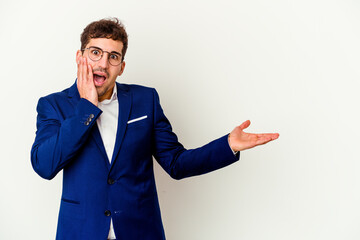 Young business caucasian man isolated on white background impressed holding copy space on palm.