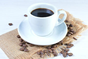 Cup of colombian coffee, decorated on white wooden background