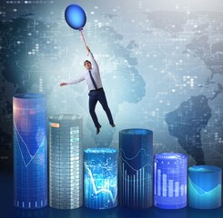 Businessman flying on hot balloon over graph