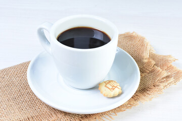 Cup of colombian coffee, decorated on white wooden background