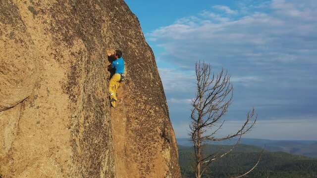 Aerial Shot Of Free Solo Climbing On Rock Wall