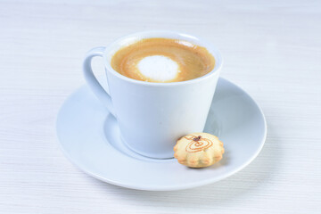 Cup of colombian coffee, decorated on white wooden background