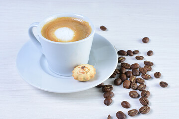 Cup of colombian coffee, decorated on white wooden background