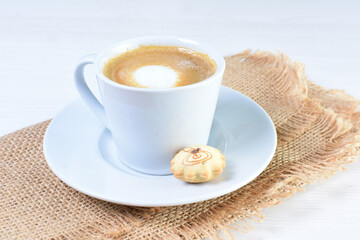 Cup of colombian coffee, decorated on white wooden background
