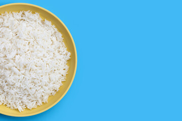 Dish of rice on blue background.