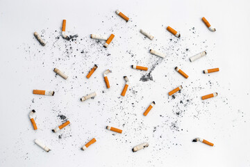 Cigarette butts and ashes on white