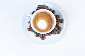 Cup of colombian coffee, decorated on white wooden background