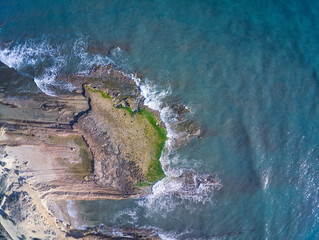 Aerial drone view of the rocks of Cabo Huertas beach in Alicante, located in the Valencian Community, Spain