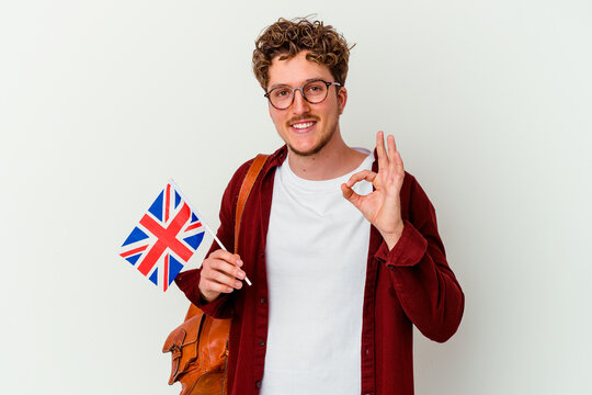 Young student man learning english isolated on white background cheerful and confident showing ok gesture.