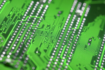Abstract macro view of green printed circuit board with shiny pins blurred background, diagonal composition