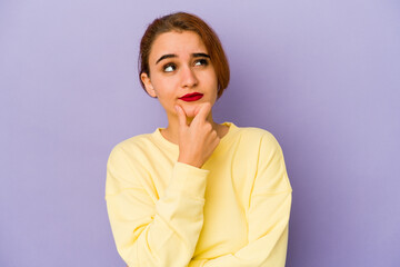 Young arab mixed race woman relaxed thinking about something looking at a copy space.