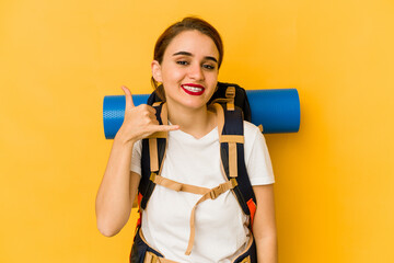 Young skinny arab traveler woman showing a mobile phone call gesture with fingers.