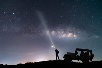 the car over the beautiful, wide blue night sky with stars and Milky way galaxy. Astronomy,...