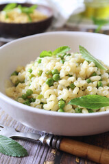Italian Cuisine. Mock risotto. Stortini pasta with green peas