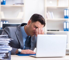Fototapeta premium Overloaded with work employee under paperwork burden
