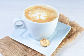 Cup of colombian coffee, decorated on white wooden background