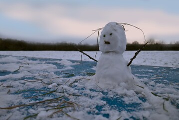 grumpy small snowman in the winter