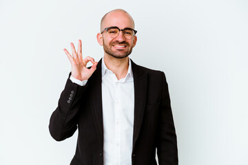 Young business caucasian bald man isolated on blue background cheerful and confident showing ok gesture.