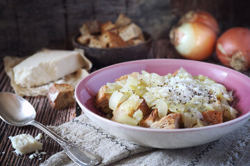 Italian Cuisine. Roman onion soup with toast bread and grated cheese