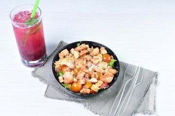 Rich very colorful vegetable salad, with croutons, strawberries, lettuce, Parmesan cheese and cherry tomato on white wooden background