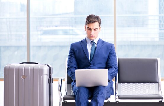 Businessman waiting at the airport for his plane in business cla