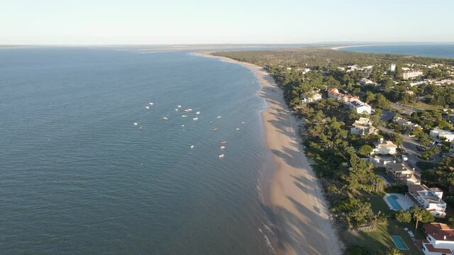 Tropical beach with white sand an small boats close to the shore